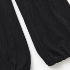Black Women's Halter Neck Jumpsuit with Cowl Neckline & Wide-Leg Pockets — Marlow - Close Up Hem Pants