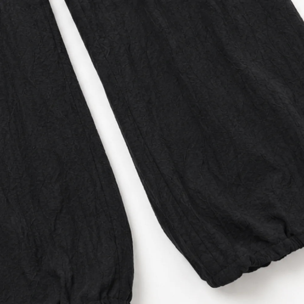 Black Women's Halter Neck Jumpsuit with Cowl Neckline & Wide-Leg Pockets — Marlow - Close Up Hem Pants