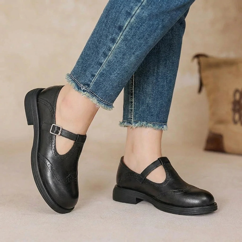 Black Women's T-Strap Leather Mary Janes — Jane Burnished Buckle Brogue - Side Pose Jeans