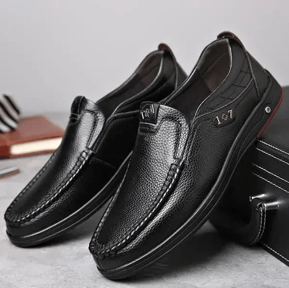Black Men's Leather Slip-On Shoes — Ethan Cushioned Moc-Toe Work Loafers - Pair Front Angled