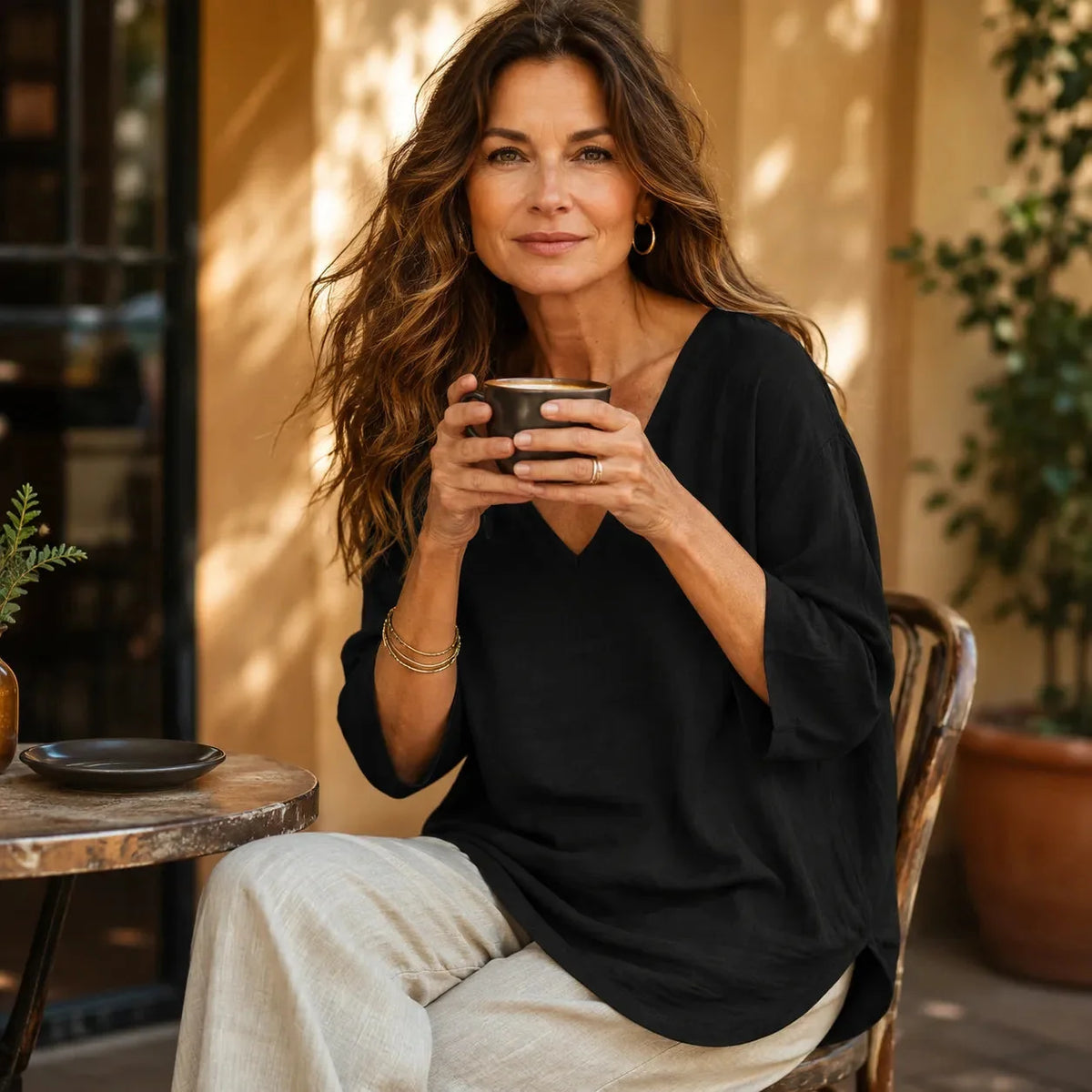 Black Women's V-Neck Linen Blouse — Elise Curved Hem Three-Quarter Sleeve Relaxed - Seated Lifestyle