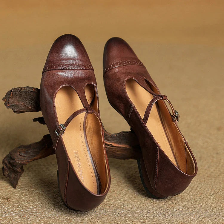 Brown Women's T-Strap Mary Leather Flats — Hannah Buckle Cap-Toe - Flat Lay Branch Prop